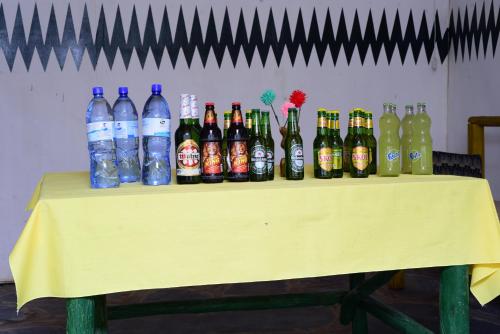 a table with a bunch of bottles of soda at ImuHira Campsite in Nyamasheke