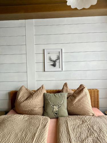 a bedroom with a bed with pillows on it at RELAX Seefeld Apartman in Seefeld in Tirol