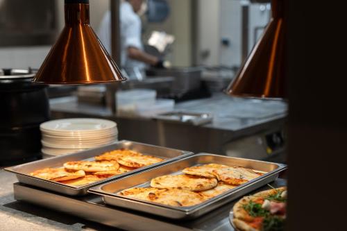 a kitchen with some food in a pan on a counter at Riserva Bianca Limone Hotel & SPA in Limone Piemonte