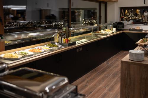 a buffet line with many plates of food at Riserva Bianca Limone Hotel & SPA in Limone Piemonte