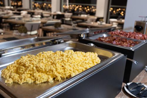 a buffet line of trays of food in a restaurant at Riserva Bianca Limone Hotel & SPA in Limone Piemonte
