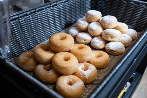 a tray of donuts with powdered sugar on them at Riserva Bianca Limone Hotel & SPA in Limone Piemonte