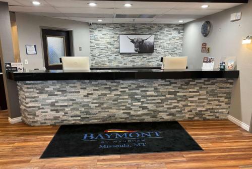 a lobby with a pay station with two laptops at Baymont by Wyndham Missoula in Missoula