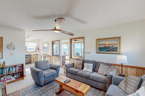 a living room with two couches and a table at Sound FX 437 in Avon