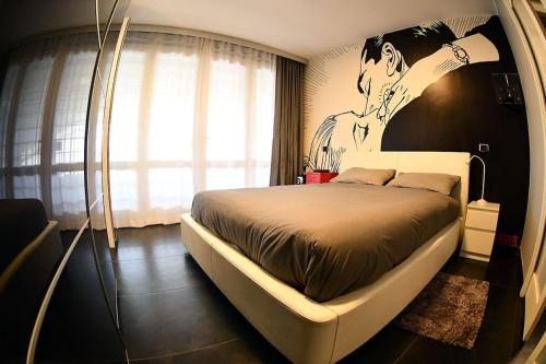 a bedroom with a bed with a painting on the wall at La casa di Gabry Prestige in Albano Laziale