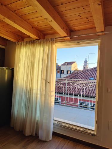 a large window with a view of a city at Parsifal House in Chioggia