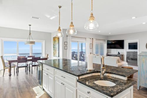 a kitchen and living room with a table and a dining room at Available for Season! St Joe A-Go-Go - Gulf Front - Pet-Friendly in Port Saint Joe