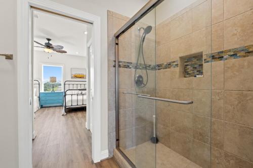 a bathroom with a shower with a glass door at Available for Season! St Joe A-Go-Go - Gulf Front - Pet-Friendly in Port Saint Joe