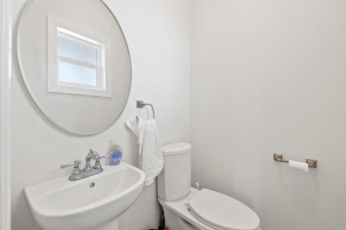 a white bathroom with a sink and a mirror at Available for Season! St Joe A-Go-Go - Gulf Front - Pet-Friendly in Port Saint Joe