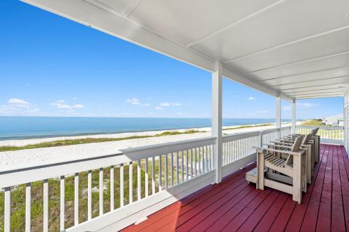 a porch with chairs and the ocean in the background at Available for Season! St Joe A-Go-Go - Gulf Front - Pet-Friendly in Port Saint Joe