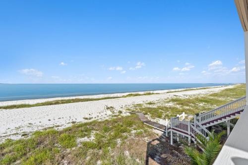 a view of the beach from the balcony of a beach house at Available for Season! St Joe A-Go-Go - Gulf Front - Pet-Friendly in Port Saint Joe