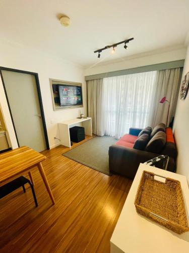 a living room with a couch and a table at The Palace Flat Moema in Sao Paulo