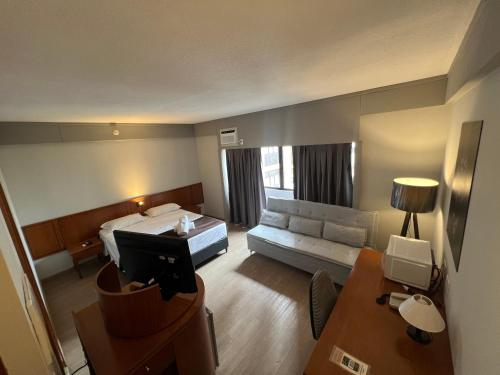 a hotel room with a bed and a couch at Hotel Live Lodge Vila Mariana Pq Ibirapuera UH402 in Sao Paulo