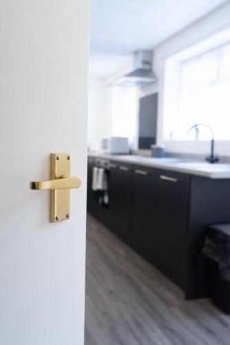 an open door to a kitchen with a sink at Carlisle Comfort Terrace in Carlisle