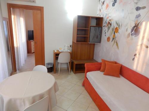 a living room with a couch and a table at Hotel Kaly in Ventimiglia