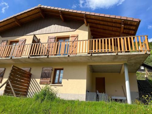 a house with a deck on the side of it at Gîte La Bresse 7 personnes in La Bresse