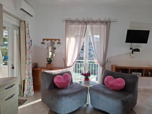 a living room with two chairs with hearts on them at La Necussella in Anacapri