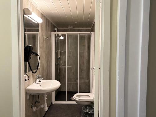 a bathroom with a toilet and a sink at Winjum Cabin Aurland Stegastein in Aurland