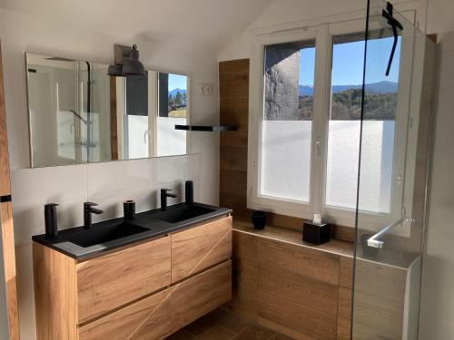 a bathroom with a black sink and a mirror at Authentique ferme Cerdane entièrement rénovée in Caldégas