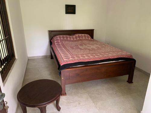 a small bedroom with a bed and a table at Mahage Polhena in Owilana