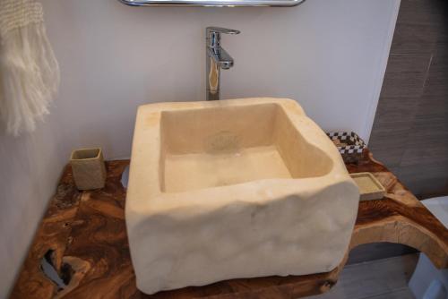 a bathroom with a sink on a wooden counter at B&B Don Alessandro in Surbo