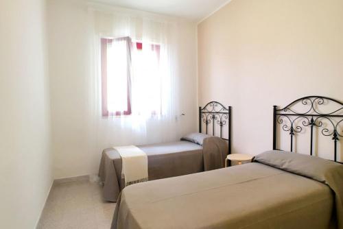 a bedroom with two beds and a window at Casa Gardenia in Torre Vado