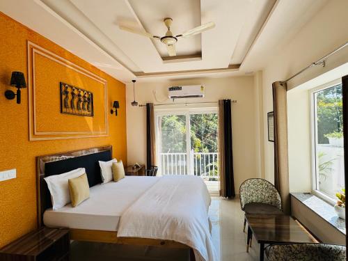a bedroom with a large bed and a window at Rootz in Dehradun