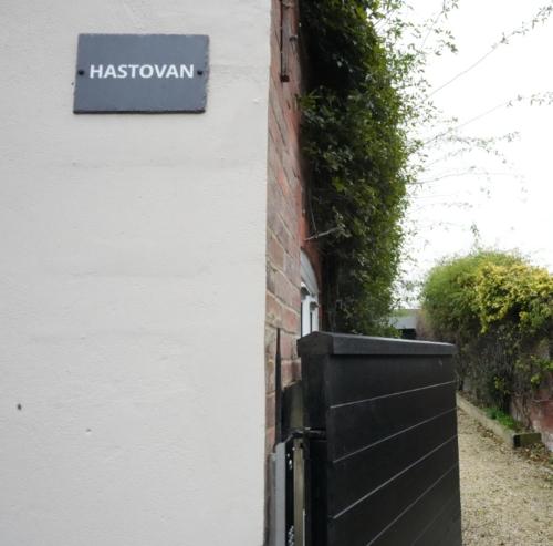 a sign on the side of a house with a black fence at Historic Wing in Tring: Cozy and Scenic in Tring