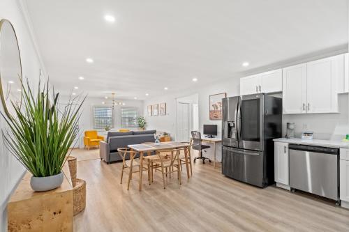 a kitchen and living room with a table and appliances at Long Bay Duplex in Myrtle Beach