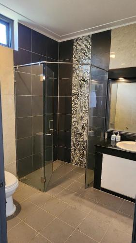 a bathroom with a shower and a toilet and a sink at ZEN Resort - Villa beach- Garden in Xóm Tram