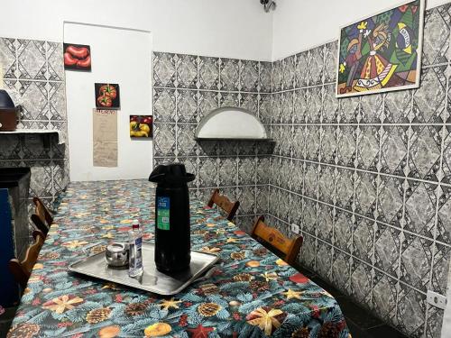 a table in a restaurant with a bottle on it at Hot Iguaçú in Sorocaba