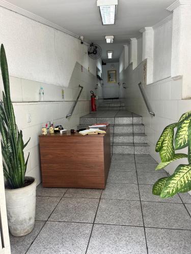 a waiting room with stairs and a reception desk at Hot Iguaçú in Sorocaba