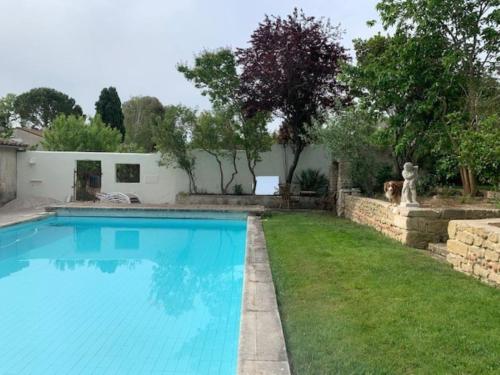 a large blue swimming pool in a yard with a yard at Terralha in Meynes