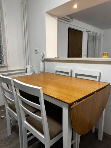 a dining room with a wooden table and chairs at Apartman Ana in Bjelovar