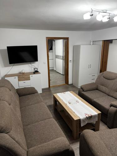 a living room with two couches and a coffee table at Apartman Ana in Bjelovar