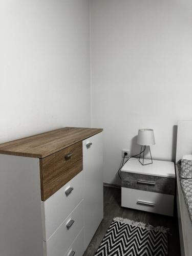a bedroom with a desk and a bed with a lamp at Apartman Ana in Bjelovar