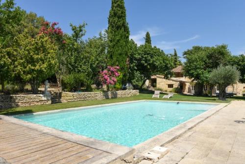 a swimming pool in a yard with a wooden deck at Terralha in Meynes