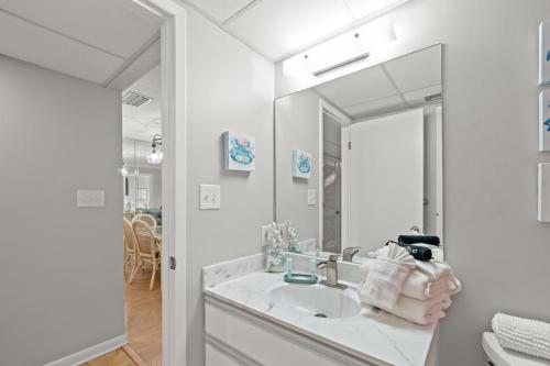 a bathroom with a sink and a mirror at Edgewater Golf Villa 1210 in Panama City Beach