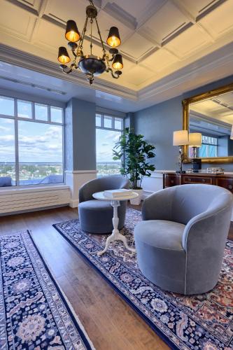 a living room with two chairs and a table and a mirror at The Executive Suites and Events in Ephrata
