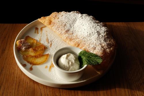 a plate of food with a piece of bread and whipped cream at Robert Hotel in Dragobrat