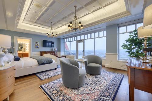 a bedroom with a bed and a desk and chairs at The Executive Suites and Events in Ephrata
