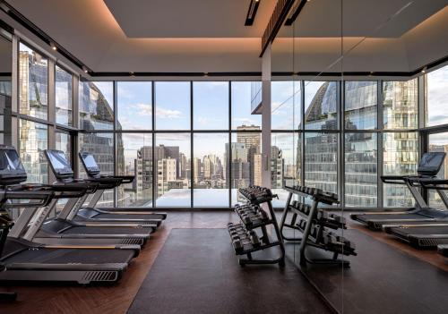 a gym with a view of a city skyline at InterContinental Bangkok Sukhumvit by IHG in Bangkok
