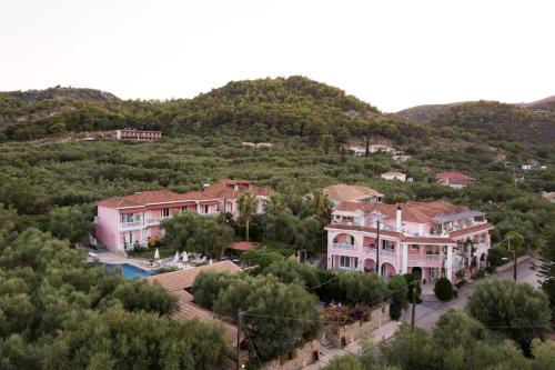a group of houses on a hill with trees at Kyprianos in Keri