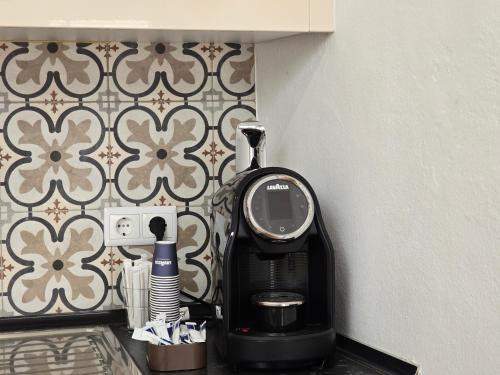 a coffee maker sitting on a counter next to a wall at Casa Sebastião in Faro