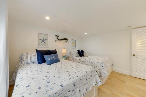 a bedroom with two beds with blue pillows at Lanai, Pool and Patios Waterfront Home in Tavernier in Tavernier