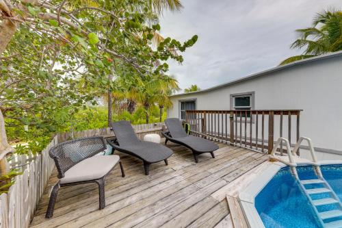 a deck with chairs and a swimming pool at Lanai, Pool and Patios Waterfront Home in Tavernier in Tavernier