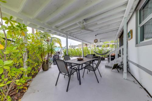 a patio with a table and chairs and plants at Lanai, Pool and Patios Waterfront Home in Tavernier in Tavernier