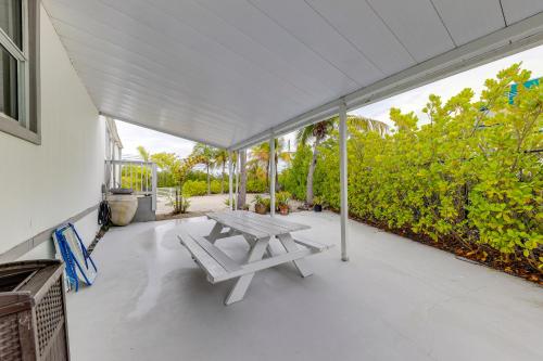 a picnic table under a white canopy on a patio at Lanai, Pool and Patios Waterfront Home in Tavernier in Tavernier
