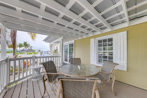 a dining room with a table and chairs on a porch at Waterfront Home with Private Hot Tub in Tavernier! in Tavernier