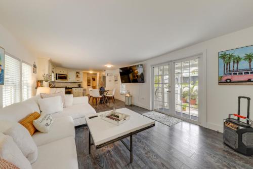 a living room with a white couch and a table at Waterfront Home with Private Hot Tub in Tavernier! in Tavernier